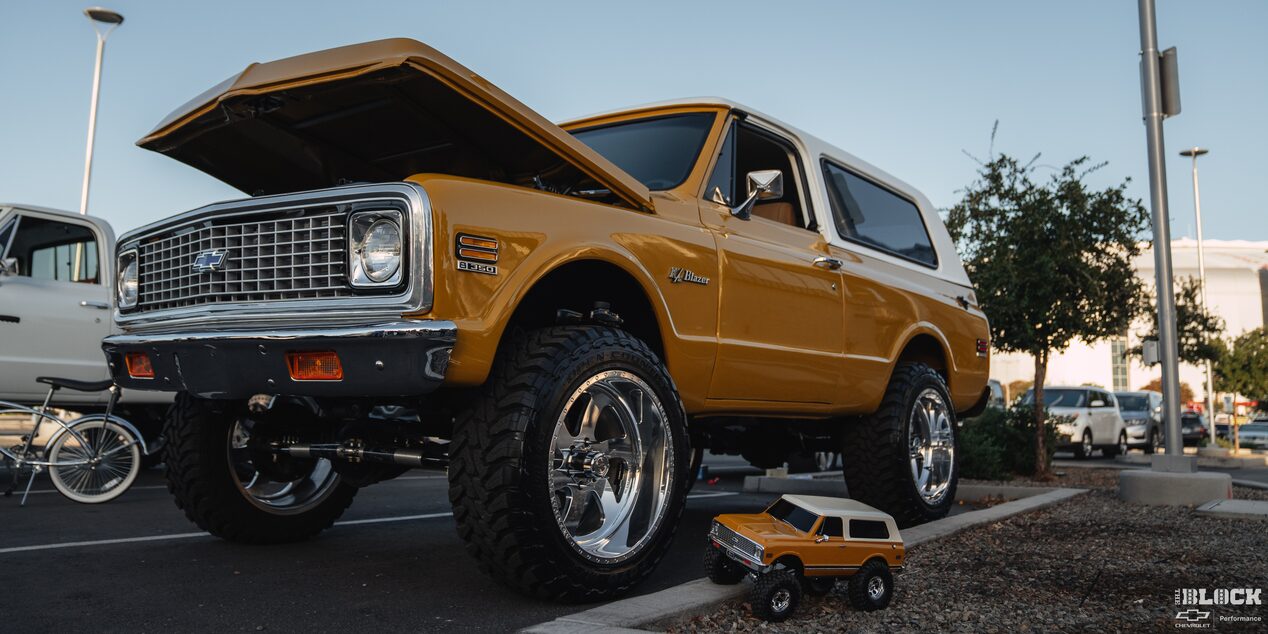 Three Quarters Low Angle View of a Chevy Blazer Parked with a Toy Version of the Same Vehicle Next to It