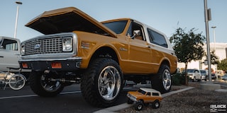 Three Quarters Low Angle View of a Chevy Blazer Parked with a Toy Version of the Same Vehicle Next to It