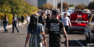 Rear View of a Man and a Woman Seen Walking at Dino’s Git Down Event