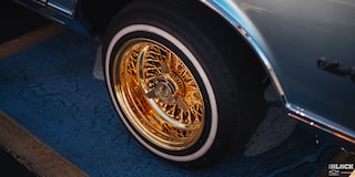 Close-up of a Rear Left Tire of a Vehicle with Golden Interior