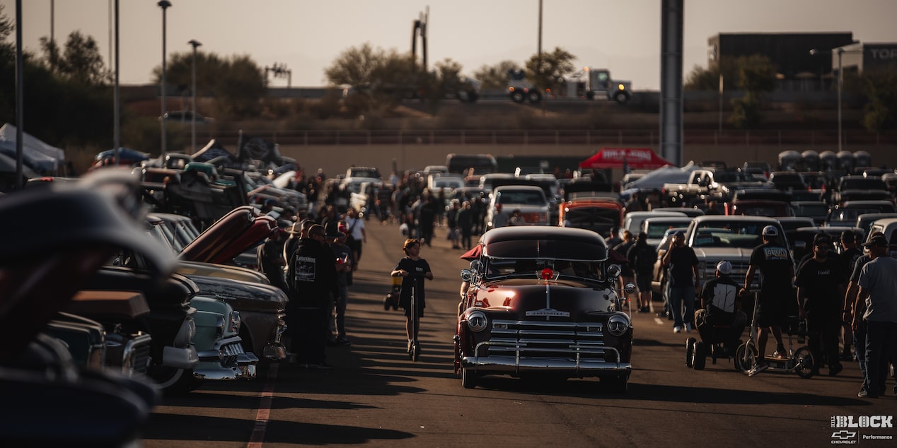 A Wide View of Many Different Vehicles Parked and People Walking around at the Dino's Git Down 2024 Event