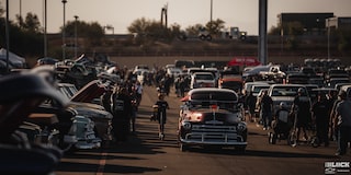 A Wide View of Many Different Vehicles Parked and People Walking around at the Dino's Git Down 2024 Event