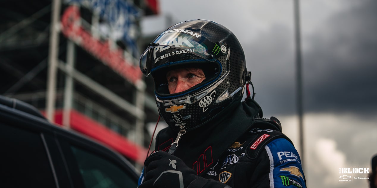 A Shot of a Racer Wearing Black Race Suite and a Helmet