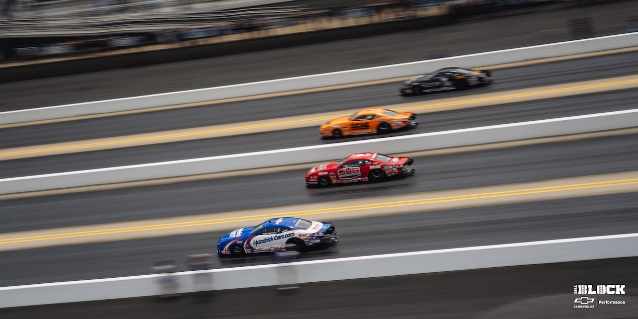 Side View of Four Custom Chevy Racecars Racing Down Their Individual Lanes
