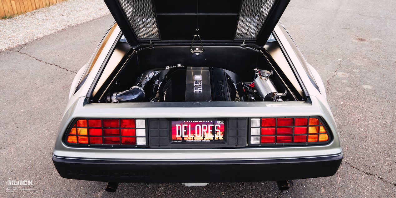 The engine is a tight fit in the rear of the DeLorean.
