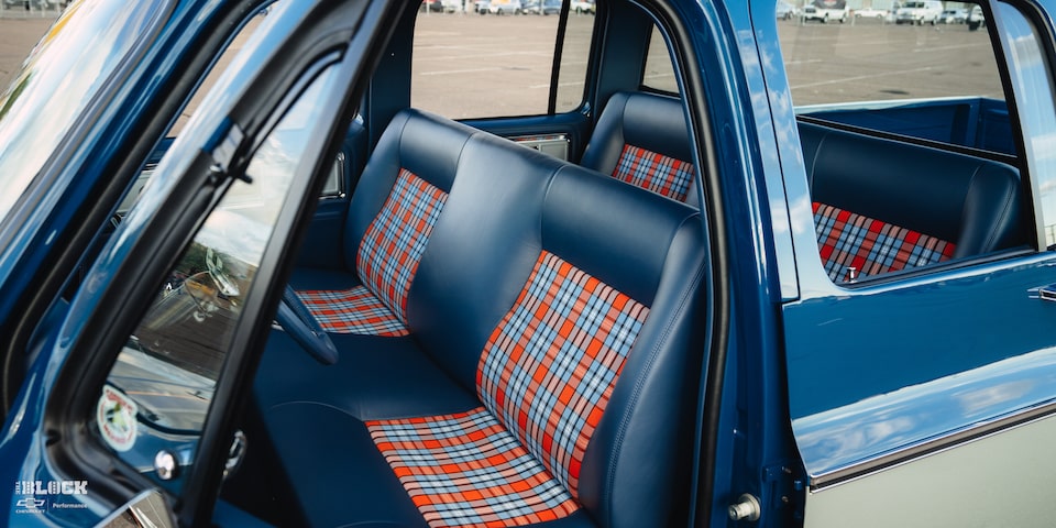 The interior utilizes a checkered blue-and-orange scheme to tie the truck’s colors together.