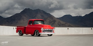 Wide Front Three-Quarters View of David Kinnison's 1957 Chevrolet 3100 Truck in a Parking Lot