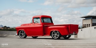 Rear Three-Quarters View of David Kinnison's 1957 Chevrolet 3100 Truck in a Parking Lot