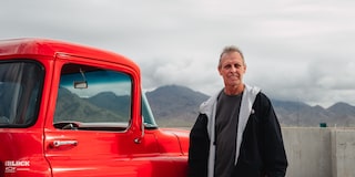 David Kinnison Standing Next to His 1957 Chevrolet 3100 Truck in a Parking Lot