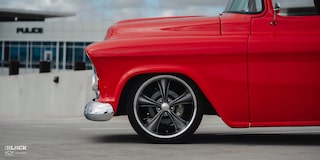 Close-up of the Wheel on David Kinnison's 1957 Chevrolet 3100 Truck in a Parking Lot