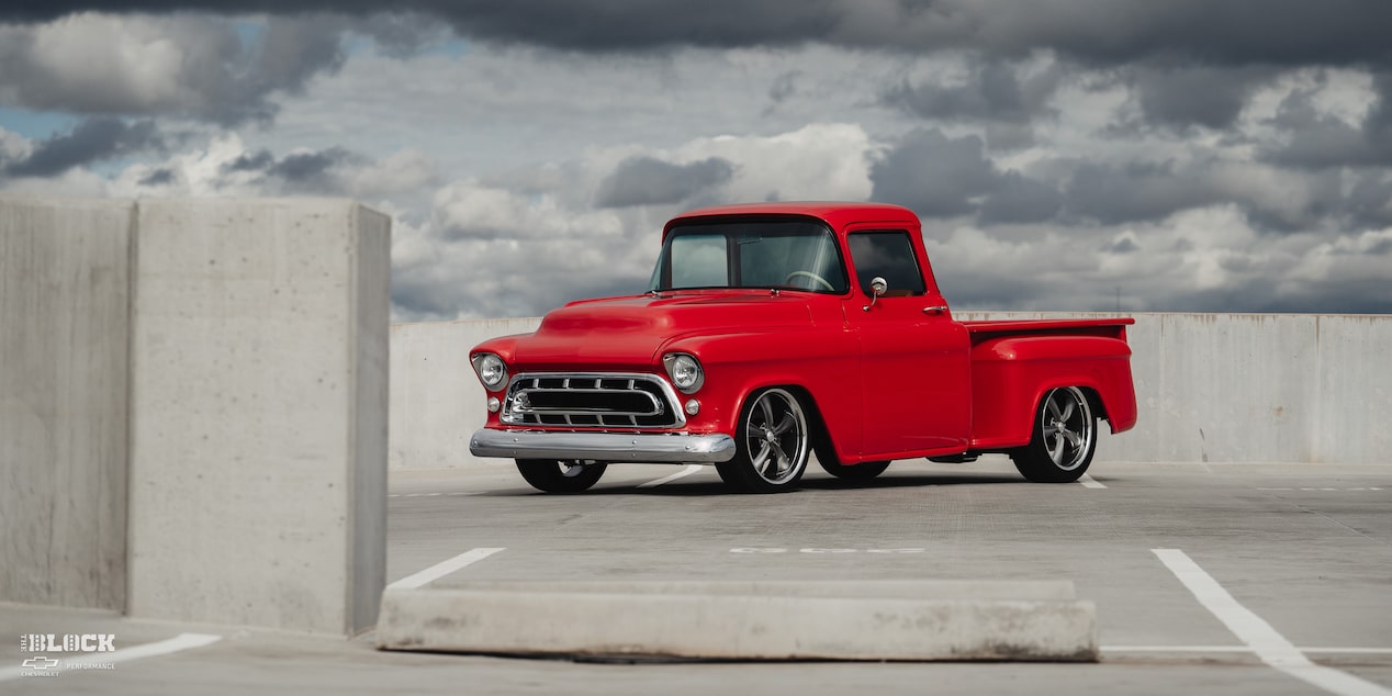 Front Three-Quarters View of David Kinnison's 1957 Chevrolet 3100 Truck in a Parking Lot
