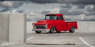 Front Three-Quarters View of David Kinnison's 1957 Chevrolet 3100 Truck in a Parking Lot
