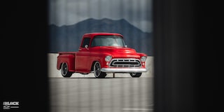 Wide Front Three-Quarters View of David Kinnison's 1957 Chevrolet 3100 Truck in a Parking Lot