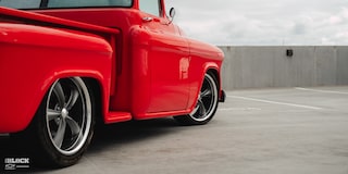 Close-up of the Wheels on David Kinnison's 1957 Chevrolet 3100 Truck in a Parking Lot
