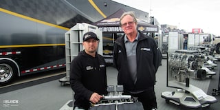 Two Chevrolet Performance Representatives Standing with a 525 RLB Chevrolet Performance Engine