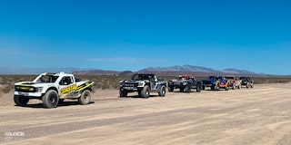 Line-up of Racing Trucks on a Dirt Path