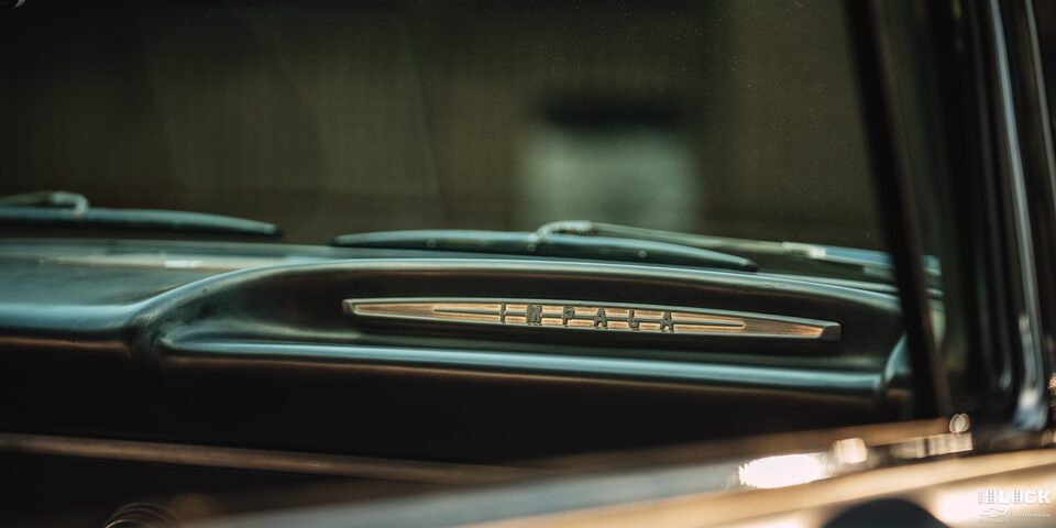 The Impala Emblem Seen from outside the Window into the Front Interior of a Chevy Impala