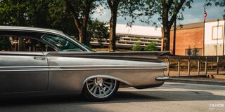 Side View of the Rear of a 1959 Chevy Impala on a Sunny Day Parked at the Side of the Road