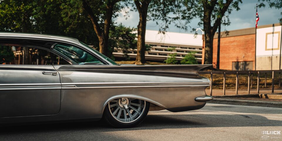 Side View of the Rear of a 1959 Chevy Impala on a Sunny Day Parked at the Side of the Road