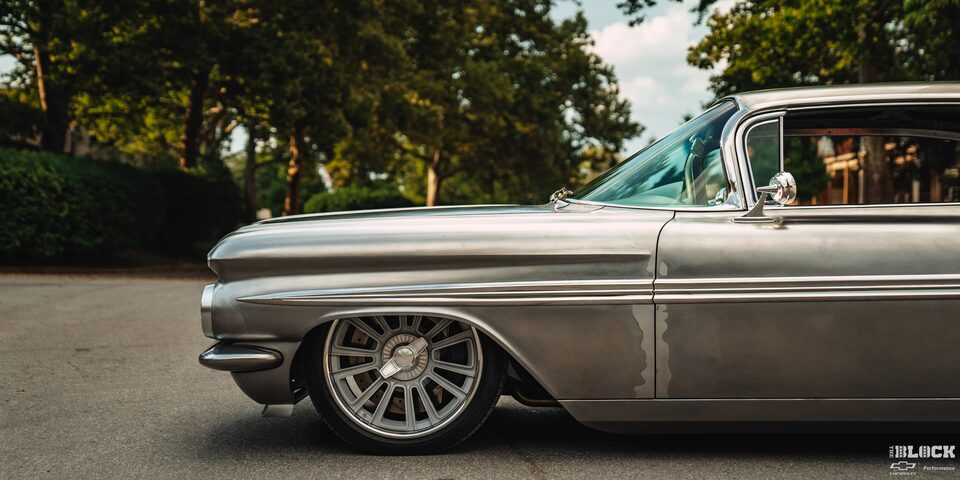 Front Side View of a 1959 Silver Chevy Impala on the Road