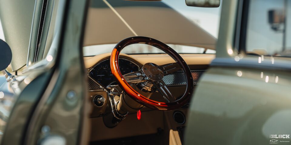 A Focused Shot of the Brown Steering Wheel from outside the Window of 1955 Chevrolet