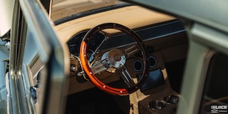 A Focused Shot of the Brown Steering Wheel from outside the Window of 1955 Chevrolet