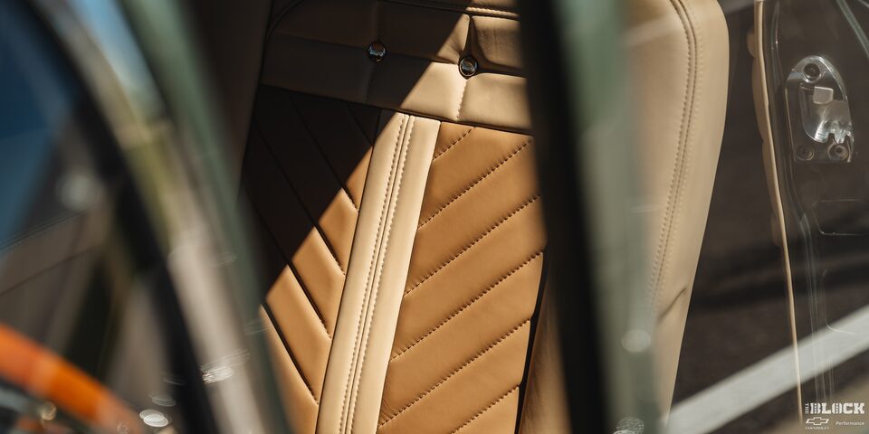 A Sunlit View of the Front Seat through the Window Cracks of the 1955 Chevrolet