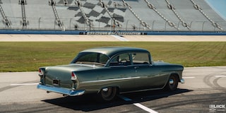Three Quarters Rear View of a 1955 Chevrolet on a Racing Track under Sunny Day
