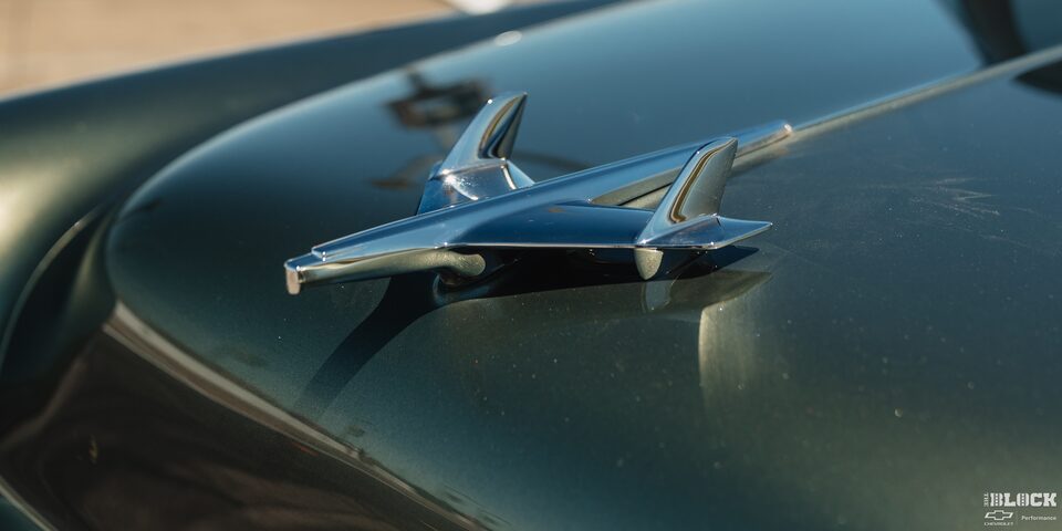 Close-up of the 1955 Chevrolet Emblem Glowing under the Sun