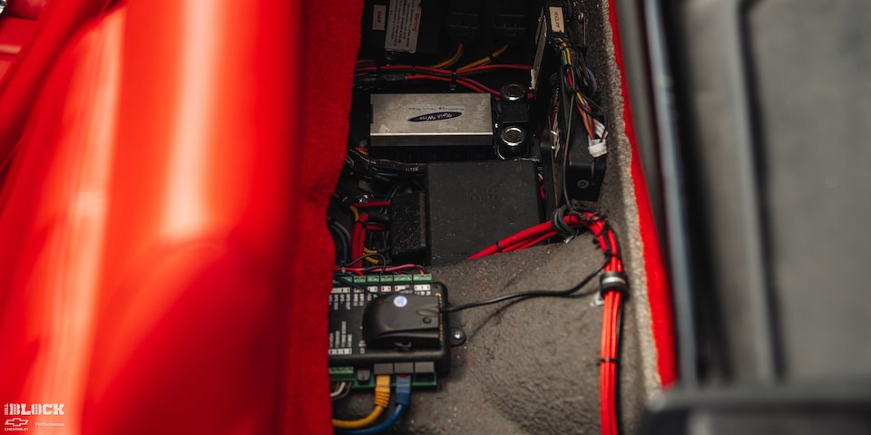 A 1969 Chevy Corvette's Circuits Exposed Behind Orange Car Seats