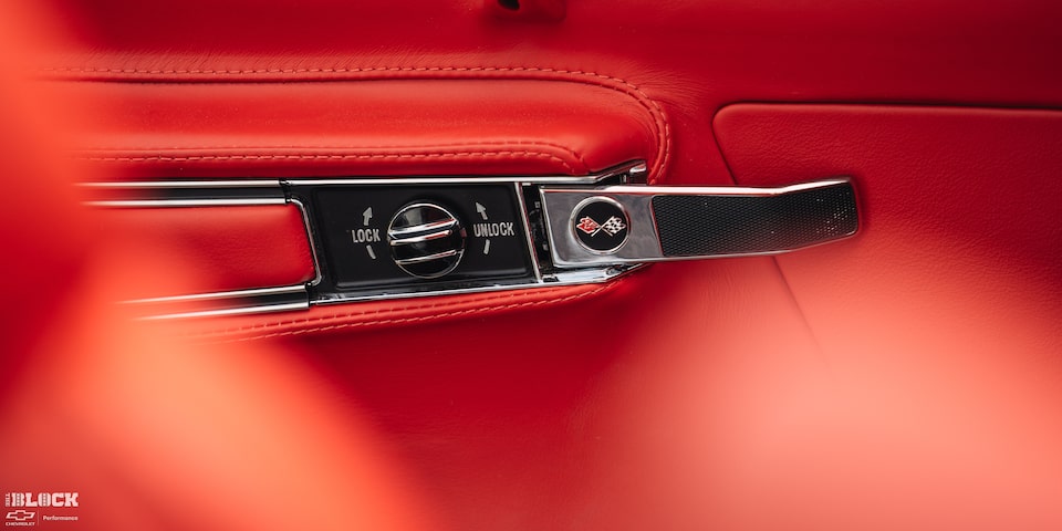 Close-up View of a 1969 Chevy Corvette Door Lock/Unlock Switch with an Orange Colored Interior