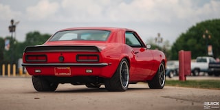 Three Quarters Rear View of an Orange 1968 Chevy Camaro on the Road