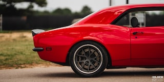 Side Rear View of a 1968 Orange Chevy Camaro on the Road