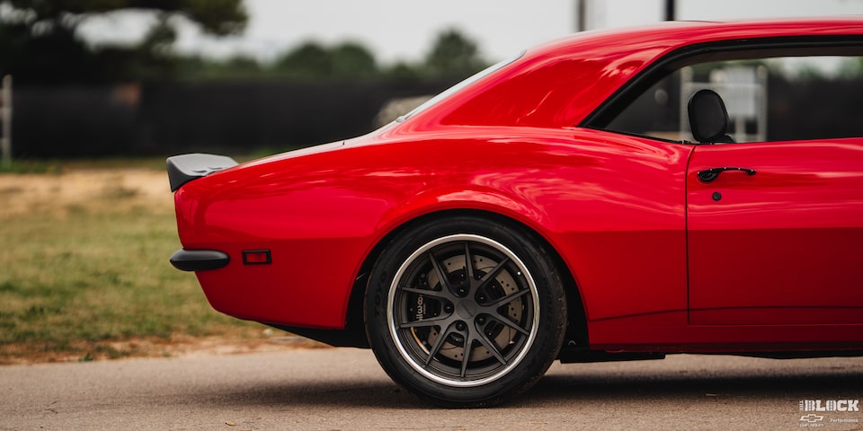 Side Rear View of a 1968 Orange Chevy Camaro on the Road