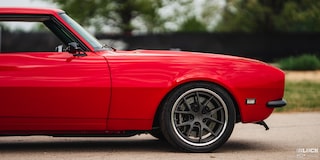 Frontal Side View of an Orange 1968 Chevy Camaro on a Road