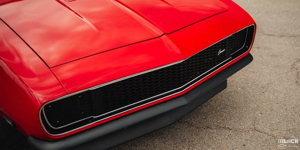 Close-up of the Front Grill and Hood of a 1968 Orange Chevy Camaro