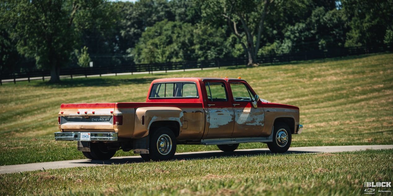 Rear View of a Red Chevy Performance Silverado Surrounded by a Grassy Field