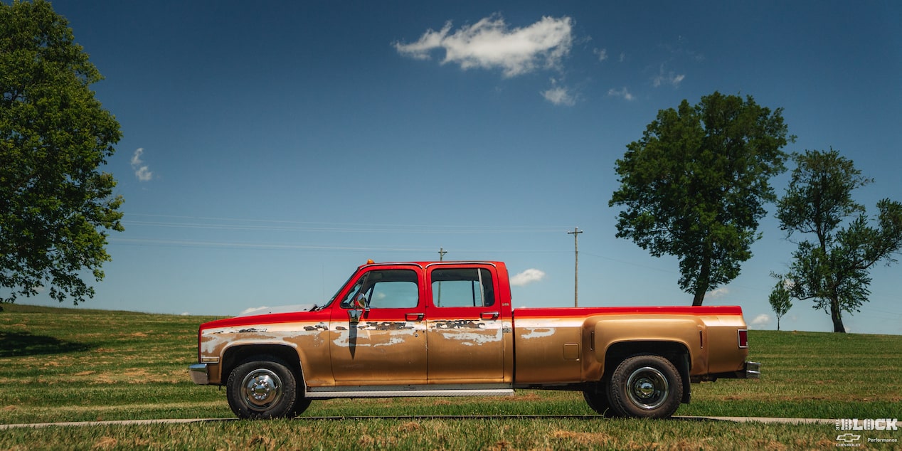 Side View of a Red Chevy Performance Silverado under a Clear Blue Sky