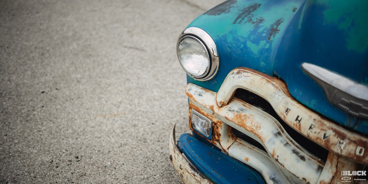 Close-up View of the Front Left Side of a 1955 Blue Chevy Pickup Truck