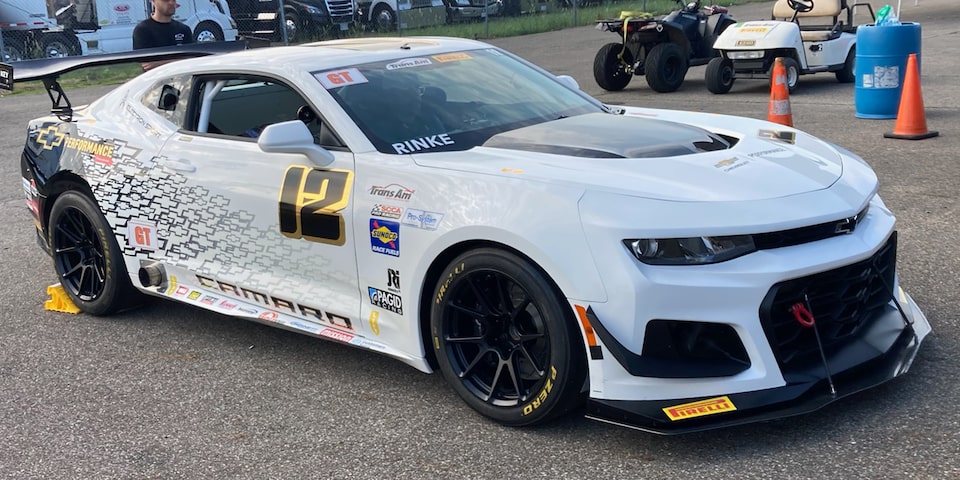 Three Quarter View of a White Chevy Camaro Parked on the Road