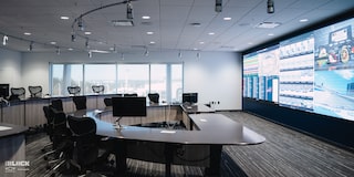 A Large Meeting Room with Specs and Data Projected Onto a Large Wall Screen at the GM Charlotte Technical Center.