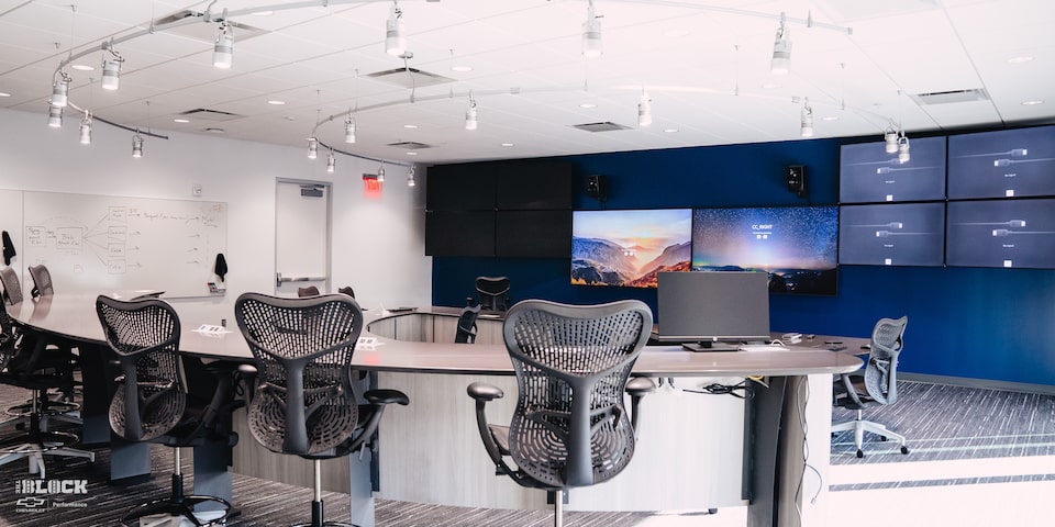 A Large Meeting Room with Mounted TV Monitors and Whiteboards at the GM Charlotte Technical Center.