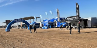 View of the Autonation Parts Center Tent as Attendees Walk By At the Parker 400 in Parker, Arizona.