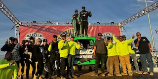 Justin Davis Stands Atop His Off-Road Racing Truck Surrounded by Crew and Family After Wining the Parker 400.