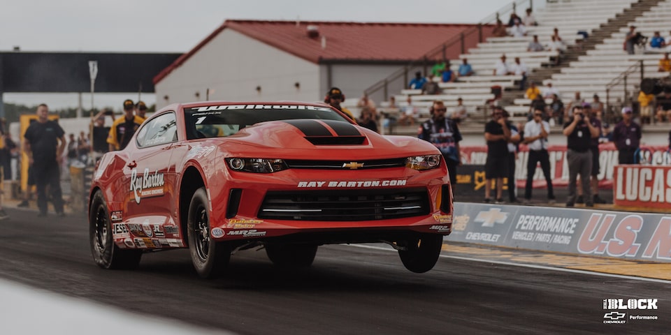 Wide Front Three-Quarters View of a Chevrolet Copo Camaro Taking Off From the Starting Line