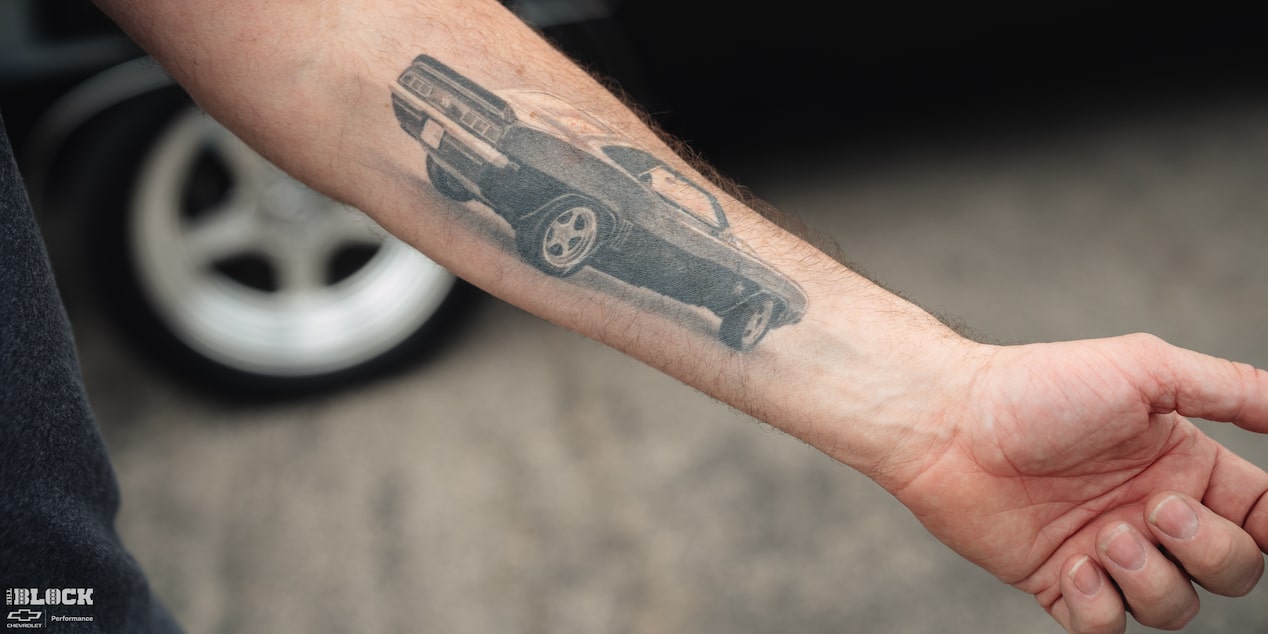 A Tattoo of Becky and Derek Luck's Vintage 1969 Chevrolet Camaro SS on Derek's Forearm