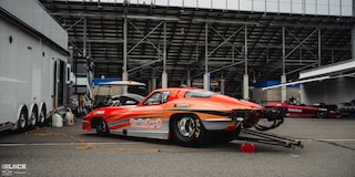 Side View of an Orange Chevrolet Funny Car Parked at Charlotte Motor Speedway
