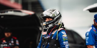 A Female Racer Stands Wearing a Racing Helmet at the 2024 NHRA 4-Wide Nationals