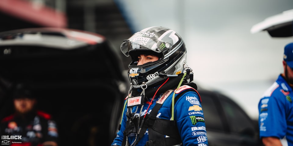 A Female Racer Stands Wearing a Racing Helmet at the 2024 NHRA 4-Wide Nationals