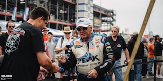 A Race Car Driver Signs an Autograph at Charlotte Motor Speedway